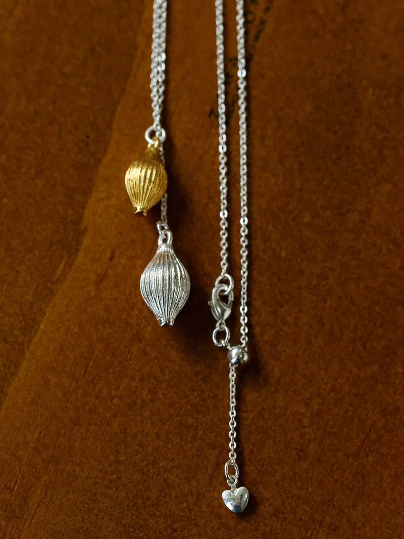 Long Gold and Silver Textured Seed Pendant Necklace